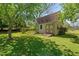 Exterior view of the shed in backyard surrounded by mature trees at 313 Ellenwood Dr, Bowdon, GA 30108