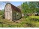 Exterior view of the shed in backyard provides extra storage space at 313 Ellenwood Dr, Bowdon, GA 30108