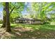 Backyard view with expansive lawn, mature trees, and the home's rear facade, creating a private oasis at 3944 Woburn Dr, Tucker, GA 30084