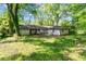 View of the home's rear exterior, showcasing the patio, expansive yard, and peaceful surroundings at 3944 Woburn Dr, Tucker, GA 30084