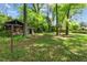 Large, tree-filled backyard featuring a storage shed, offering plenty of space for recreation and outdoor living at 3944 Woburn Dr, Tucker, GA 30084
