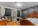 Cozy bedroom with hardwood floors, dark wallpaper, and antique furniture at 3944 Woburn Dr, Tucker, GA 30084