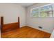 Bright bedroom with hardwood floors, fresh paint, and natural light from two windows at 3944 Woburn Dr, Tucker, GA 30084