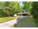 A well-maintained home featuring a long driveway and a convenient covered carport area at 3944 Woburn Dr, Tucker, GA 30084