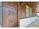 Exterior shot of the unique front door design featuring decorative wood panels and white brick at 3944 Woburn Dr, Tucker, GA 30084