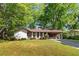 Charming one-story home with white brick, covered parking, and a lush green lawn at 3944 Woburn Dr, Tucker, GA 30084