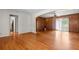 Open-concept living room with hardwood floors, wood paneling, and natural light at 3944 Woburn Dr, Tucker, GA 30084
