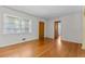 A living room with hardwood floors, natural light, and neutral paint at 3944 Woburn Dr, Tucker, GA 30084
