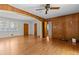 Living room with hardwood floors, wood paneling, and an open floor plan at 3944 Woburn Dr, Tucker, GA 30084