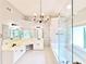 Bright bathroom featuring dual sinks, white cabinetry, a soaking tub, and a separate glass-enclosed shower at 505 Tilbury Dr, Suwanee, GA 30024