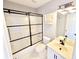 Bathroom featuring a shower with black-framed glass doors, a white vanity, and tile flooring at 505 Tilbury Dr, Suwanee, GA 30024