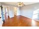 Bedroom with hardwood floors, neutral walls, ceiling fan, and an en-suite bathroom at 505 Tilbury Dr, Suwanee, GA 30024
