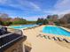 Resort-style community pool area with lounge chairs, shade umbrellas, and clear blue water for relaxation at 505 Tilbury Dr, Suwanee, GA 30024