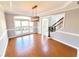 Dining room featuring a modern light fixture and large windows with a view of the front yard at 505 Tilbury Dr, Suwanee, GA 30024