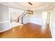 Elegant dining room featuring hardwood floors, wainscoting, modern chandelier, and stairway access at 505 Tilbury Dr, Suwanee, GA 30024