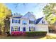 Beautiful two-story home with lush landscaping, bright blue shutters, and a spacious two-car garage at 505 Tilbury Dr, Suwanee, GA 30024
