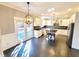 Bright kitchen with gray tile floors, white cabinets, stainless steel appliances, and a center island at 505 Tilbury Dr, Suwanee, GA 30024