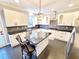 Modern kitchen featuring an island with seating, stainless steel appliances, and subway tile backsplash at 505 Tilbury Dr, Suwanee, GA 30024