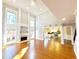Open-concept living room featuring large windows, high ceilings, a fireplace, and hardwood floors at 505 Tilbury Dr, Suwanee, GA 30024
