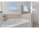 Clean bathroom featuring a large tub and a glass enclosed shower at 725 Mcwilliams Se Rd, Atlanta, GA 30315