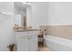 Bright bathroom with granite countertops, and tub with tile surround at 725 Mcwilliams Se Rd, Atlanta, GA 30315