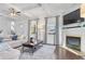 Bright living room featuring coffered ceiling, modern fireplace, and hardwood floors at 725 Mcwilliams Se Rd, Atlanta, GA 30315