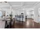 Open-concept living area with hardwood floors flowing into the kitchen with white cabinets and breakfast bar seating at 725 Mcwilliams Se Rd, Atlanta, GA 30315