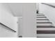 Modern staircase with dark wood steps and white risers at 725 Mcwilliams Se Rd, Atlanta, GA 30315
