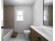 Bright bathroom featuring a tub, modern marble floors and walls, and a wood vanity with a white countertop at 7771 A C Smith Rd, Cumming, GA 30028