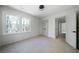This spacious bedroom features neutral carpet, freshly painted walls, double door closet, and a window view to nature at 7771 A C Smith Rd, Cumming, GA 30028