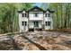 Charming two-story home with painted brick, dormers, and welcoming front porch at 7771 A C Smith Rd, Cumming, GA 30028