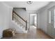 Bright foyer with hardwood floors, staircase, and classic trim at 7771 A C Smith Rd, Cumming, GA 30028