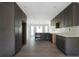 Spacious kitchen with dark cabinets, hardwood floors, and modern backsplash at 7771 A C Smith Rd, Cumming, GA 30028