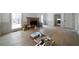 A living room featuring hardwood floors, white trim, a fireplace, and large windows at 7771 A C Smith Rd, Cumming, GA 30028