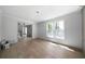Bright and airy living room featuring hardwood floors and large window at 7771 A C Smith Rd, Cumming, GA 30028