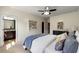Cozy bedroom featuring neutral walls, a ceiling fan, and an ensuite bathroom with a granite-topped vanity at 2808 Broughton Se Ln, Atlanta, GA 30339
