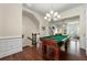 Spacious game room featuring hardwood floors, a pool table, and views into the living area at 2808 Broughton Se Ln, Atlanta, GA 30339