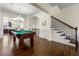 Spacious game room with billiard table, chandelier, and hardwood floors at 2808 Broughton Se Ln, Atlanta, GA 30339