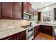 The kitchen boasts granite countertops, stainless appliances, and wood cabinetry at 2808 Broughton Se Ln, Atlanta, GA 30339