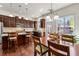 Open kitchen and dining area with stainless steel appliances, granite counters, and hardwood floors at 2808 Broughton Se Ln, Atlanta, GA 30339
