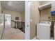 Upstairs hallway with laundry room, including washer, dryer and storage at 2808 Broughton Se Ln, Atlanta, GA 30339