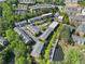 Aerial view showcasing the community's layout, green spaces, and serene pond surrounded by lush trees at 2808 Broughton Se Ln, Atlanta, GA 30339