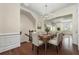 Open concept dining room with hardwood floors with adjacent staircase at 2808 Broughton Se Ln, Atlanta, GA 30339