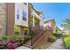 Charming brick townhouse with a grand entrance, featuring a beautiful stairway and colorful flowerbeds at 2808 Broughton Se Ln, Atlanta, GA 30339
