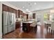 Modern kitchen with stainless steel refrigerator, kitchen island with seating, and a dining area at 2808 Broughton Se Ln, Atlanta, GA 30339