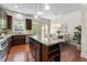 Open kitchen with dark wood cabinets, granite countertops, and stainless steel appliances at 2808 Broughton Se Ln, Atlanta, GA 30339