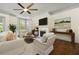 Spacious living room with fireplace, ceiling fan, and large windows for natural light at 2808 Broughton Se Ln, Atlanta, GA 30339