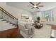 Bright living room with staircase, fireplace, and large windows for plenty of natural light at 2808 Broughton Se Ln, Atlanta, GA 30339