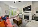 Comfortable living room with a fireplace, bay window and stylish decor at 2808 Broughton Se Ln, Atlanta, GA 30339