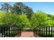 Inviting porch view with black railings offering a peaceful view of surrounding greenery and blue skies at 2808 Broughton Se Ln, Atlanta, GA 30339
